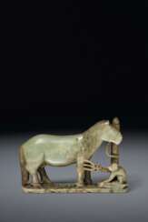 A GREYISH-GREEN JADE CARVING OF A HORSE AND MONKEY