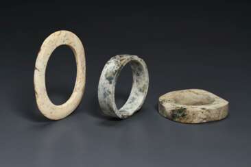 THREE MOTTLED OPAQUE BUFF JADE BRACELETS