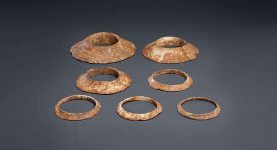 A GROUP OF SEVEN BROWNISH-IVORY-COLORED OPAQUE STONE FLANGED... - photo 1