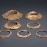 A GROUP OF SEVEN BROWNISH-IVORY-COLORED OPAQUE STONE FLANGED... - photo 1