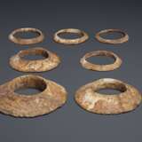 A GROUP OF SEVEN BROWNISH-IVORY-COLORED OPAQUE STONE FLANGED... - фото 2