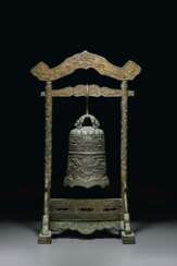 A RARE DATED PARCEL-GILT BRONZE TEMPLE BELL AND A STAND