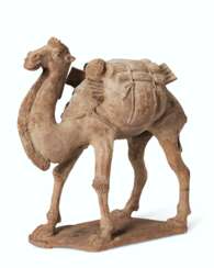 A PAINTED POTTERY FIGURE OF A STRIDING BACTRIAN CAMEL
