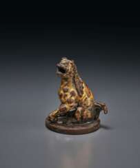 A RARE GILT-BRONZE FIGURE OF A SEATED ROARING LION