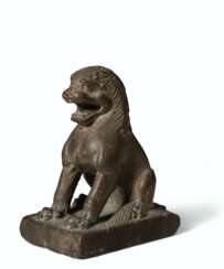 A LIMESTONE FIGURE OF A SEATED LION