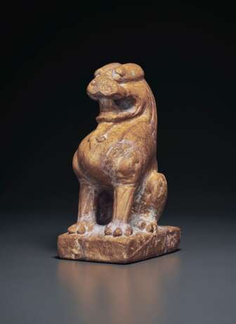 AN AMBER-COLORED STONE FIGURE OF A SEATED LION - photo 2
