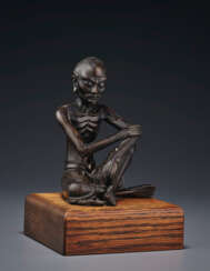 A SILVER-INLAID BRONZE FIGURE OF A SEATED LUOHAN