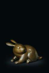 A BRONZE AND SILVER INLAID MODEL OF A RABBIT