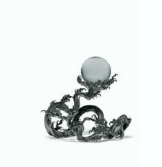 A ROCK CRYSTAL SPHERE ON A SILVER WAVE STAND