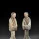 A PAIR OF PAINTED POTTERY FIGURES OF ATTENDANTS - фото 1
