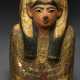 AN EGYPTIAN PAINTED WOOD, BRONZE, LIMESTONE AND GLASS UPPER PORTION OF A COFFIN LID - photo 1