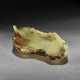 A WELL-CARVED GREEN AND BROWN JADE LOTUS LEAF-FORM WASHER - фото 1