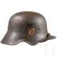 Stahlhelm M 18 mit Ohrenausschnitt zur Weiterverwendung bei der Wehrmacht - фото 1