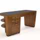 Rationalist centre desk with six drawers and two shelves. Milan, 1930s. Solid and veneered wood frame, black opaline top, leather-covered bands, aqua green painted interiors. (200x80.5x92 cm.) (professional restoration) | | Provenance | Private co - photo 1