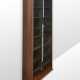 Bookcase model "Zibaldone". Produced by Bernini, Italy, 1974. Solid and veneered wood, green glass doors sliding vertically on counterweighted straps. (116x258x40 cm.) (slight defects) | | Literature | G. Gramigna, Repertorio del design italiano 19 - Foto 1