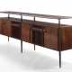(Attributed) | Sideboard. 1960s. Six doors and six legs, double top shelf. Solid and veneered dark wood. (302.3x103x47 cm.) | | Provenance | Private collection, Cantù - фото 1