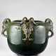 Large green enamelled ceramic cahepot under glaze, with satyr's head-shaped handles. Golfe Juan, France, early 20th century. Inscribed on the side: "CLEMENT MESSIER / GOLFE - JUAN (A. M.). (h 36.5 cm.; d 56 cm.) (slight defects) - photo 1