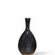 A BLACK-GLAZED BOTTLE VASE - photo 1