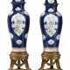 A MASSIVE PAIR OF CHINESE EXPORT PORCELAIN FAMILLE ROSE BLUE-GROUND SOLDIER VASES AND COVERS - photo 1