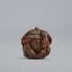 A CARVED WOOD NETSUKE OF A ONI UNDER HAT - фото 1