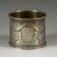 A SILVER PARCEL-GILT NAPKIN HOLDER WITH PEASANTS - photo 1