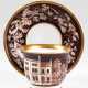 KPM-Tasse mit UT, datiert "Johann Chutholt 1857", mit architektonischer Darstellung und Floraldekor in Braun, Goldränder, UT mit Floraldekor auf braunem Grund, Goldränder, blaue Zeptermarke, Tasse zusätzl. mi… - photo 1