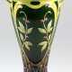 Jugendstil-Vase, Majolika, mit farbig glasiertem und z.T. goldkonturiertem Floralrelief, unterhalb vom durchbrochenen Rand 2 kleine Henkel, unter ovalem Fuß Preß-Nr. 20858, Wandung mit Haarrissen, H. 39 cm - photo 1