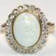 Opal-Brillant-Ring, 333er GG, ausgefaßt mit 1 ovalen Vollopal-Cabochon und 22 Brillanten im Altschliff von zus. ca. 0,18 ct., Ges-Gew. 4,07 g, RG 56 - фото 1