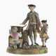 A porcelain group with chestnut seller and two putti - photo 1