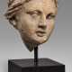 AN ETRUSCAN TERRACOTTA HEAD OF A GODDESS - фото 1
