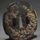 Iron tsuba in mokko form with shibuichi and gold i… - photo 1 Iron tsuba in mokko form with shibuichi and gold i… - photo 1