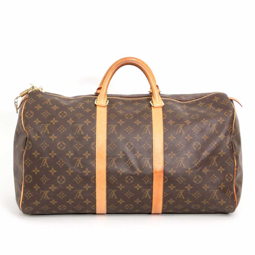 Sold at Auction: A Louis Vuitton Keepall 55 bag with shoulder strap and  luggage label. Measures 21 3/4 x 12 1/4 x 9 1