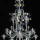 A large Venetian multicoloured and transparent 21 lights Murano glass chandelier with 16 S-shaped branches and spouts, 4 concave spiral columns ending in spouts and with turned connection to the upper central crown - фото 1