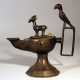 Oriental oil lamp on central canted foot with one spout, round shape and quadratic handgrip with a bird on top - photo 1
