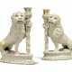 A PAIR OF CONTINENTAL FAIENCE CANDLESTICKS MODELLED AS SEATED LIONS - photo 1