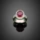 Round diamond white gold ring with a central red corundum - фото 1