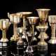Lot consisting of nine trophy cups from the Fascist period in silver-plated brass and ebonized wood, decorated with lictor's fasces of various shapes - фото 1
