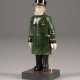 A CARVED HARDSTONE MODEL OF A MAN IN UNIFORM - photo 1
