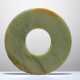 A SMOOTHLY POLISHED BI DISC WITH SHINY SURFACES CARVED FROM GREEN JADE WITH BROWN STRIPES - фото 1