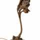 Bronze Art Nouveau table lamp with a slightly golden patina depicting a female figure looking out from inside a flower that supports it. Austria, 1900ca. Marble base. (h 40 cm.) - Foto 1
