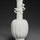 A SMALL WHITE-GLAZED LOBED `CHILONG’ BOTTLE VASE - фото 1