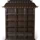 A CHINESE STYLE GOLD-PAINTED AND BROWN-LAQUERED PAGODA-FORM BOOKCASE - фото 1