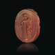 A GREEK CARNELIAN SCARAB WITH A YOUTH LEANING ON A STAFF - photo 1
