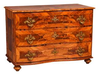 Baroque chest of drawers with fittings crowned by putti Baroque chest of drawers with fittings crowned by putti