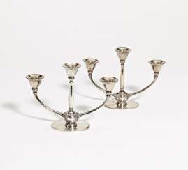 Pair of three-armed silver candlesticks Pair of three-armed silver candlesticks