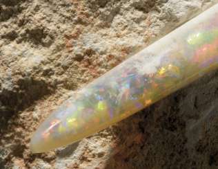 A RAINBOW BELEMNITE IN MATRIX A RAINBOW BELEMNITE IN MATRIX