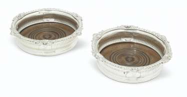 A PAIR OF GEORGE III SILVER WINE COASTERS A PAIR OF GEORGE III SILVER WINE COASTERS