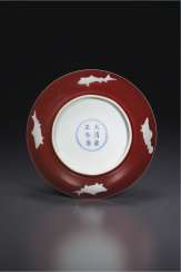 A RARE RESERVE-DECORATED COPPER RED-GLAZED DISH A RARE RESERVE-DECORATED COPPER RED-GLAZED DISH