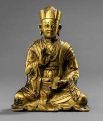 Fire gilt Bronze of a seated priest Fire gilt Bronze of a seated priest