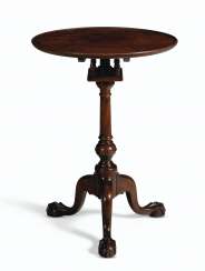 A CHIPPENDALE CARVED MAHOGANY TILT-TOP CANDLESTAND A CHIPPENDALE CARVED MAHOGANY TILT-TOP CANDLESTAND